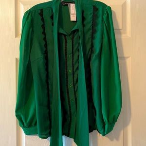 Green blouse with bow and black lace trim.